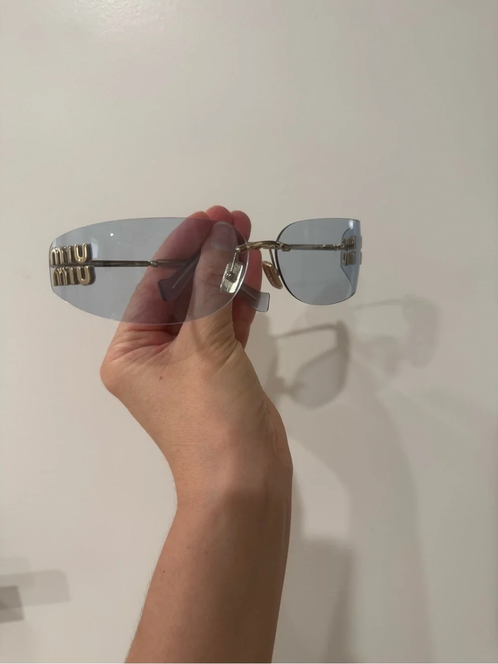 Miu Miu Light Blue Rimless Sunglasses with Gold Logo Accents